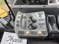 Control panel of a 2012 Caterpillar 980 featuring joysticks and buttons for operating the machine