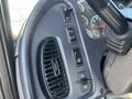 Dashboard controls and air vents of a 2005 Freightliner M2 106 showing buttons for various functions and a steering wheel in close view