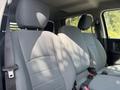 Interior of a 2013 RAM 5500 with two gray upholstered front seats and a simple design showing headrests and seat belts