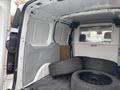 A 2019 Ford Transit Connect van with a spacious cargo area containing several stacked tires on the floor
