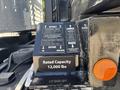 Control panel of a 2020 Peterbilt 330 showing instructions for loading and unloading the deck with a label for rated capacity of 12000 lbs