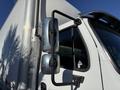A 2012 Freightliner M2 106 truck with a silver side mirror mounted on a black support arm attached to the driver's side door