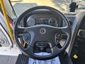 Steering wheel of a 2022 Lion Lion6 with control buttons and a digital dashboard displaying various readings and information