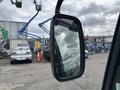 A side mirror of a 2019 Madvac LS175 showing a reflection of a cloudy sky and nearby vehicles
