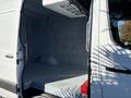 A 2021 Mercedes-Benz Sprinter 2500 with a spacious empty cargo area and a side door opened for access