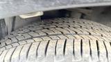 Close-up of a textured tire from a 2019 Nissan Kicks showing detailed tread pattern and accumulated dirt