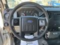 The interior view of a 2011 Ford F-550 showcasing the steering wheel dashboard and control panel