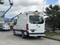 A 2020 Mercedes-Benz Sprinter 2500 parked with a white exterior and red accents featuring emergency lights on the roof and a rear door design specifically for cargo access