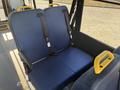 Interior seating of a 2017 Ford Transit-350 featuring two blue upholstered seats with yellow grab handles and seatbelt attachments