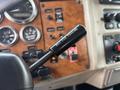 A close-up of a gear shift lever in a 2008 Peterbilt 340 with a label stating NOT FOR PARTING