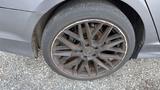 A close-up of a gray 2018 Hyundai Sonata wheel featuring multi-spoke alloy rim and worn tire with visible dirt and debris on the surface