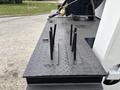 A close-up view of the textured metal surface of a 2013 Freightliner 114SD with several black cylindrical posts protruding vertically from it