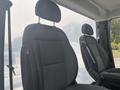Interior view of a 2023 RAM Promaster 3500 showcasing two spacious grey cloth front seats with adjustable headrests
