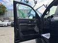 A 2021 RAM 1500 with an open driver's side door showcasing the interior features and controls
