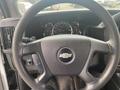 Steering wheel of a 2016 Chevrolet Express displaying the logo and control buttons on the left side