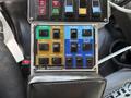 A control panel with various colored buttons and switches labeled for functions like power auger pre-wet spinner anti-ice and boom controls on a 2013 Freightliner 114SD