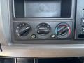 Control panel of a 2020 Peterbilt 330 with three dial knobs for settings and a switch for additional functions