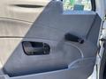 The interior door panel of a 2011 International 4300 featuring a black handle a door lock control and a smooth gray surface