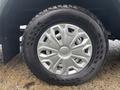Close-up of a silver wheel with a unique spoke design mounted on a tire labeled Nokian HT 5