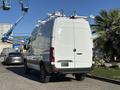 A white 2024 Mercedes-Benz Sprinter 2500 van with roof racks parked on a driveway
