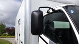 Close-up of the side mirror on a white 2016 Hino 195 truck with a partially visible cab and gray cargo box