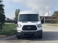 A white 2016 Ford Transit 150 van is parked facing forward with a black grille and two front windows visible