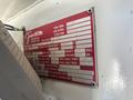 A red and white label affixed to a vehicle displaying specifications and information for a 2008 Peterbilt 340 truck