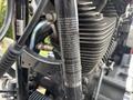 Close-up of the engine of a 2009 Harley-Davidson Road King with visible details on the engine and an emissions label attached to the frame