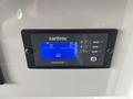 A control panel display with a blue backlight showing battery status and settings for a power management system in a 2020 Mercedes-Benz Sprinter 2500 vehicle
