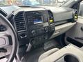 Interior view of a 2020 Ford F-150 dashboard featuring a touchscreen display and control knobs