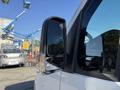 A side view mirror of a 2023 Mercedes-Benz Sprinter 2500 with a clear reflective surface and integrated turn signal indicator