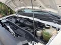 The image shows the engine compartment of a 2008 Ford Econoline with visible components like the air intake throttle and coolant reservoir