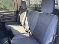 Interior view of the back seat of a 2014 RAM 5500 with gray fabric upholstery and seating for three passengers