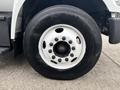 Close-up of a white wheel and tire from a 2018 Ford F-750 featuring multiple lug nuts and a tread pattern designed for durability and traction
