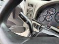 Close-up of the turn signal and wiper control lever on a 2012 International TerraStar steering column with dashboard gauges visible in the background