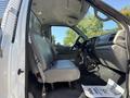 Interior of a 2004 Ford F-750 showing front seats dashboard and gear shift in a gray color scheme