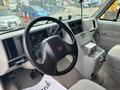 Interior view of a 1994 GMC Vandura 3500 showing the steering wheel dashboard and center console with controls and gauges