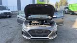 A 2018 Hyundai Sonata with its hood open and front doors ajar displaying the engine compartment