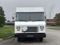 A 2012 Ford E-450 Super Duty delivery truck with a white exterior and a front grille featuring horizontal slats and a diamond-shaped panel in the center
