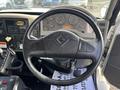 The steering wheel and dashboard of a 2012 International DuraStar 4300 showing various gauges and controls