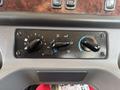 Dashboard controls of a 2022 Freightliner M2 106 featuring three black knobs for temperature fan speed and air circulation settings