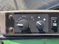 Control panel of a 2021 John Deere 1575 featuring two dials and a switch for various functions