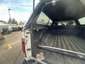 A 2012 RAM 2500 with its tailgate lowered showing the truck bed interior and a sliding rear window
