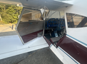 A 1986 Sorrell Hiperbipe SNS-7 amateur-built aircraft with an open cockpit featuring an array of flight instruments and a two-tone maroon and white color scheme