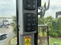 Controls and dashboard of a 2012 Caterpillar 980 including buttons for various functions and an instruction panel