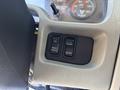 Control panel of a 2013 International 7500 featuring three buttons labeled ON PARKD RECEN DUMP and SUSP