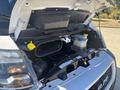 A 2020 RAM ProMaster 3500 with its hood raised revealing the engine compartment and various engine components including a coolant reservoir