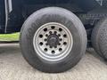 A close-up of a Goodyear tire on a 2013 Freightliner 114SD with visible wheel rim and lug nuts
