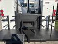 The image shows the rear of a 2005 Freightliner M2 106 featuring a metal platform with steps grab rails and lights