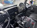 Interior view of a 2013 International DuraStar 4300 truck showing the dashboard steering wheel and control panel with various switches and gauges